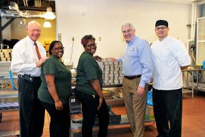 Cooking up meals from scratch are, from left, Volunteers of America Vice President of Resource and Business Development Al Kohorst, staff members Amicia Bailey and Chasity Porter,  James LeBlanc and Fresh Food Factor Assistant Director Jim Zelaya.  Fresh Food Factor Program Director is Lawrence Dodds. Photo Credit: Nijme Rinaldi Nun