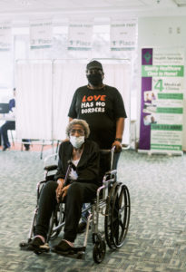 lady being helped in wheelchair